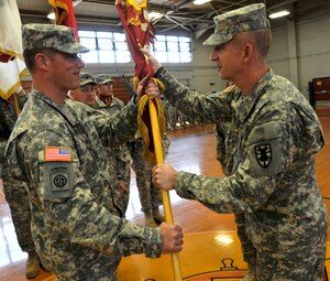 U.S. Army Col. Stephen Cherry IV, 7th Sustainment Brigade Commander, right, passes the guidon to Lt. Col. Stephen W. Ledbetter, incoming commander of the 53rd Transportation Battalion, during a change of command ceremony at Anderson Field House, Fort Eustis, Va., Feb. 2012. Lt. Col. Ledbetter’s previous position was chief of operations at Fort Bragg, N.C. (U.S. Army Photo by Sergeant 1st Class Kelly Jo Bridgwater/Released)