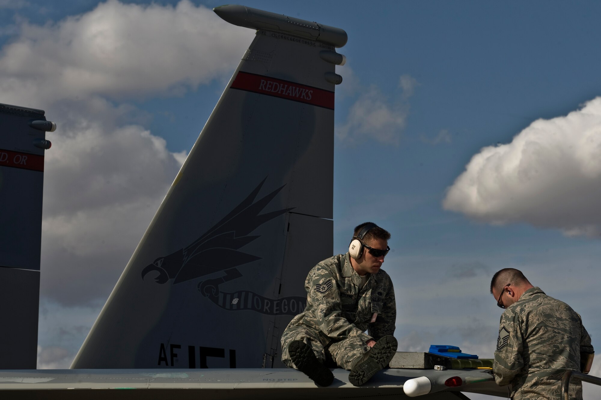 U.S. Air Force Master Sgt. Randy Stone, avionics electrician, and Staff Sgt. Matthew Shelburne, crew chief, both with the 142nd Aircraft Maintenance Squadron, Portland Air National Guard, conduct maintenance on an F-15C Eagle during Red Flag 12-3 Feb. 28, 2012, at Nellis Air Force Base, Nev. Red Flag is a realistic air-to-air combat training exercise involving the air forces of the United States and its allies.(U.S. Air Force photo by Airman 1st Class Daniel Hughes)