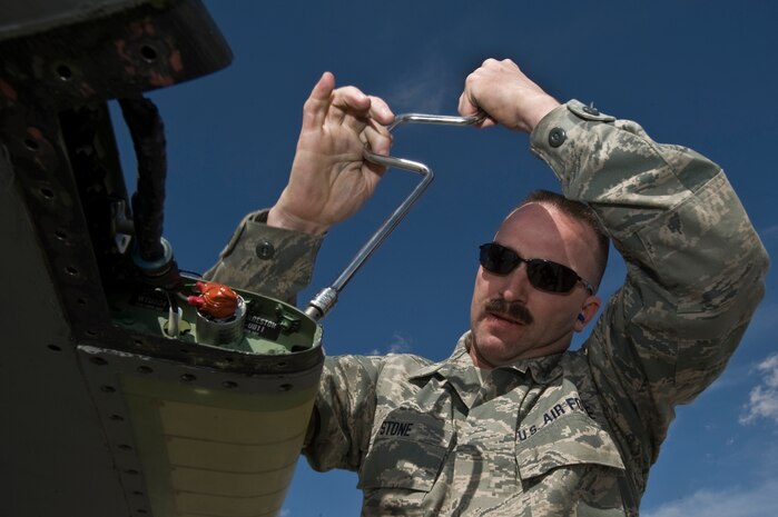 U.S. Air Force Master Sgt. Randy Stone, avionics electrician, 142nd Aircraft Maintenance Squadron, Portland Air National Guard, replaces a wingtip position light on an F-15C Eagle during Red Flag 12-3 Feb. 28, 2012, at Nellis Air Force Base, Nev. Red Flag is a realistic air-to-air combat training exercise involving the air forces of the United States and its allies.(U.S. Air Force photo by Airman 1st Class Daniel Hughes)