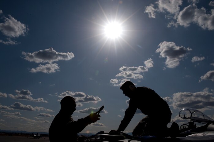 U.S. Air Force Master Sgt. Randy Stone, avionics electrician, and Staff Sgt. Matthew Shelburne, crew chief, both with the 142nd Aircraft Maintenance Squadron, Portland Air National Guard, conduct maintenance on an F-15C Eagle during Red Flag 12-3 Feb. 28, 2012, at Nellis Air Force Base, Nev. Red Flag is a realistic air-to-air combat training exercise involving the air forces of the United States and its allies.(U.S. Air Force photo by Staff Sgt. Christopher Hubenthal)
