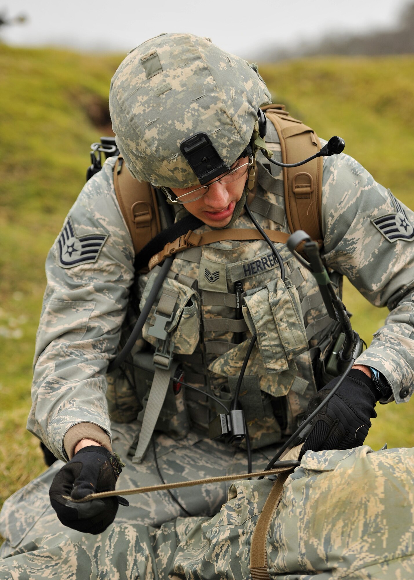 NORFOLK, England – Staff Sgt Gilbert Herrera, 100th Security Forces Squadron, secures a tourniquet during a simulated deployment mission at Stanford Training Area, Norfolk, Feb. 28, 2012. Prior to “deploying,” the teams went through two days of classroom instruction covering basic combat skills and tactics. (U. S. Air Force photo/Senior Airman Jerilyn Quintanilla)