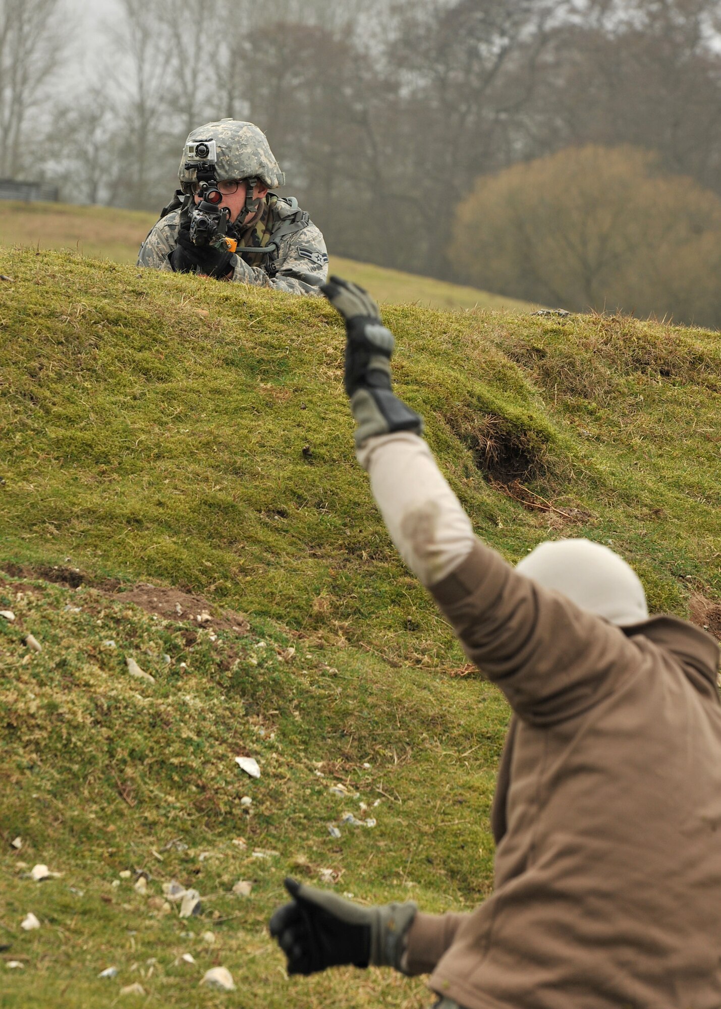 NORFOLK, England – Airman 1st Class Patrick Dowling, 100th Security Forces Squadron, provides cover during an enemy Prisoner-of-War search as part of a simulated deployment mission at Stanford Training Area, Norfolk, Feb. 28, 2012. The field training offered the Airmen from the 100th SFS hands on experience of potential real world deployment scenarios. (U.S. Air Force photo/Senior Airman Jerilyn Quintanilla)