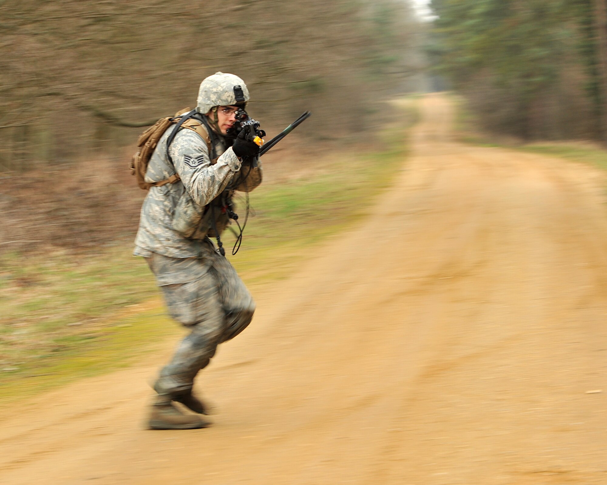 NORFOLK, England – Staff Sgt. Gilbert Herrera, 100th Security Forces Squadron, runs past a danger crossing during a simulated deployment mission at Stanford Training Area, Norfolk, Feb. 28, 2012. The purpose of the mission was to test team cohesion and communication. They also practiced basic combat skills and self-aid buddy care. (U.S. Air Force photo/Senior Airman Jerilyn Quintanilla)