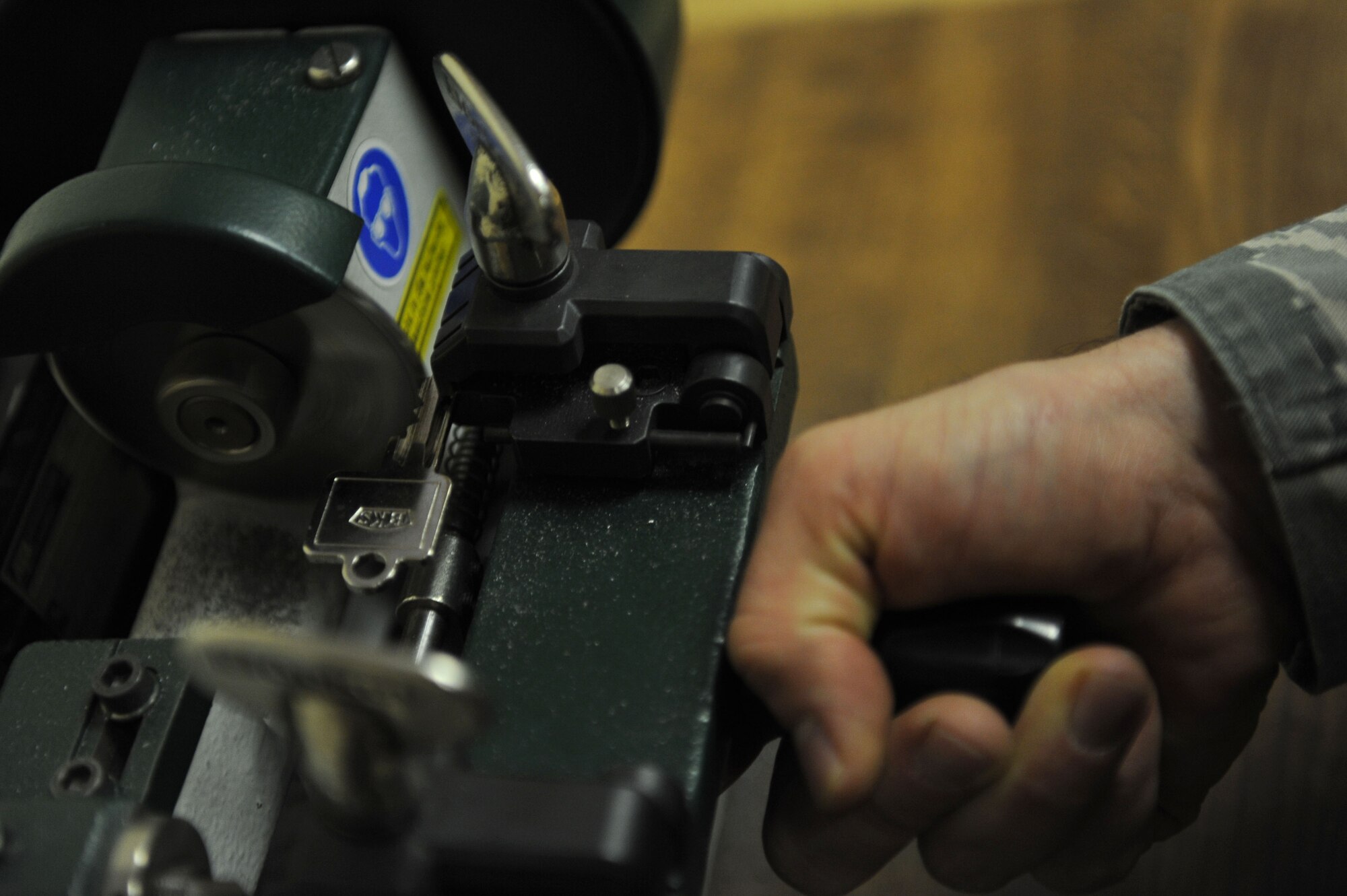 SPANGDAHLEM AIR BASE, Germany - Tech. Sgt. Damon Weigl, 52nd Civil Engineer Squadron structural craftsman, uses a key cutting machine to create keys in the lock shop at Bldg. 120 here Feb. 28. The lock shop performs maintenance on safes, doors, vaults and a variety of different locks and keys. The shop provides support to Spangdahlem AB and all its geographically-separated units keeping more than 1,700 facilities secure. This support keeps facilities secure keeping our base safe for air force assets and airman and their families. (U.S. Air Force photo by Senior Airman Christopher Toon/Released)