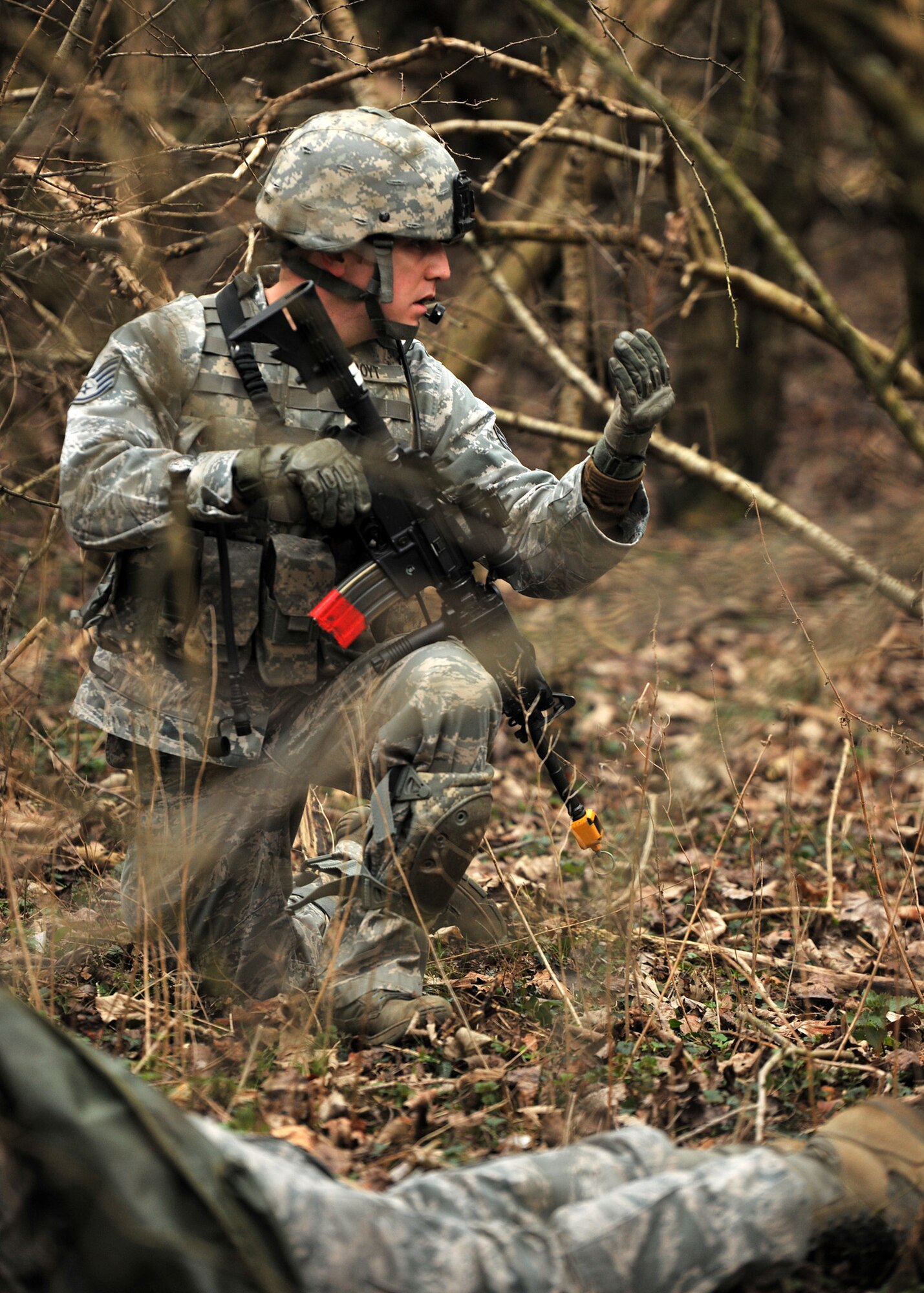 NORFOLK, England – Staff Sgt. Houston Boyt, 100th Security Forces Squadron, uses hand signals to communicate with his team during a simulated deployment mission at Stanford Training Area, Norfolk, Feb. 28, 2012. The purpose of the mission was to test team cohesion and communication. (U.S. Air Force photo/Senior Airman Jerilyn Quintanilla)