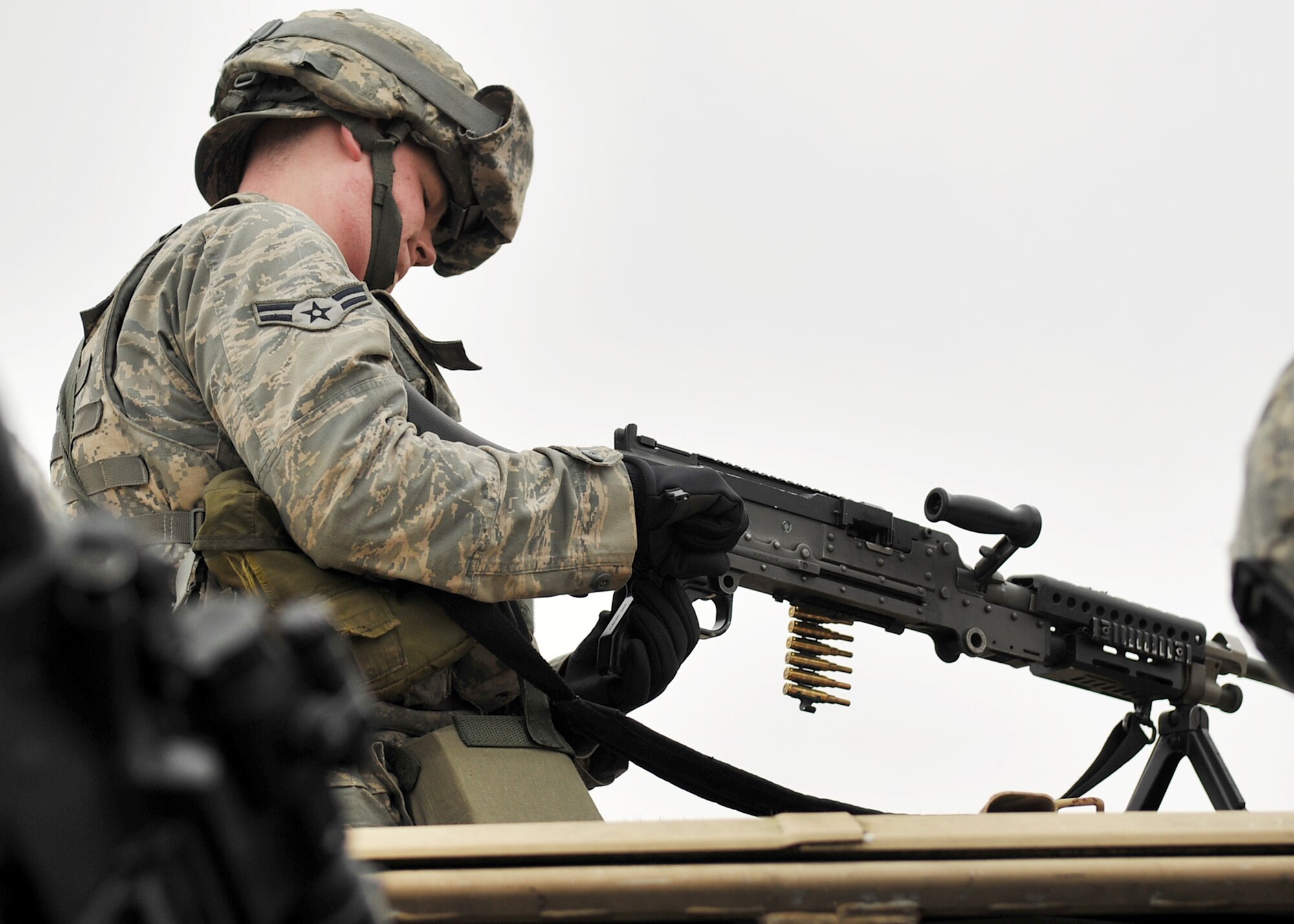 NORFOLK, England - Airman 1st Class Marcus Crawford, 100th Security Forces Squadron, loads his weapon prior to a simulated deployment mission at Stanford Training Area, Norfolk, Feb. 28, 2012. Crawford, along with 25 other 100th SFS Airmen, assisted the Royal Air Force by simulating joint service operations as part of their pre-deployment training requirements. They also conducted field training, fulfilling squadron requirements. (U.S. Air Force photo/Senior Airman Jerilyn Quintanilla)