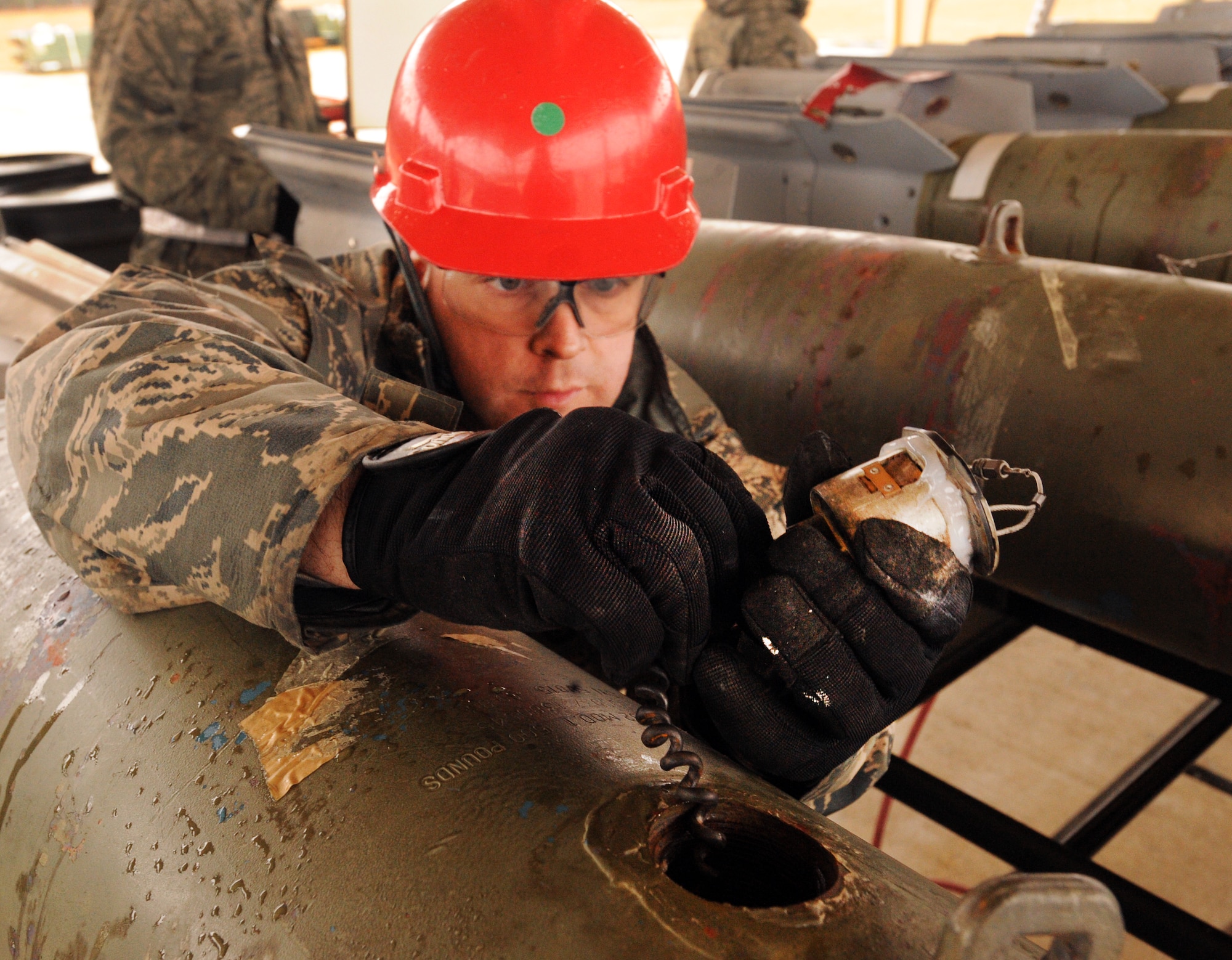 U.S. Air Force Tech. Sgt. David Coughtry, 20th Equipment Maintenance Squadron munitions flight conventional maintenance crew supervisor, attaches the inert guided bomb units fuse at Shaw Air Force Base, S.C., Feb. 27, 2012. The 20th EMS munitions flight built inert guided bomb units to load on to Shaw's F-16 Fighting Falcons to demonstrate warlike scenarios for an upcoming Operation Readiness Exercise. (U.S. Air Force photo by Senior Airman Tabatha McCarthy/Released)