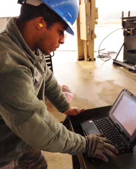U.S. Air Force Senior Airman Lamont Crawford-Dolphin, 20th Equipment Maintenance Squadron munitions flight conventional maintenance crew, looks over the technical order manuals at Shaw Air Force Base, S.C., Feb. 27, 2012. The 20th EMS munitions flight built inert guided bomb units to load on to Shaw's F-16 Fighting Falcons to demonstrate warlike scenarios for an upcoming Operation Readiness Exercise. (U.S. Air Force photo by Senior Airman Tabatha McCarthy/Released)