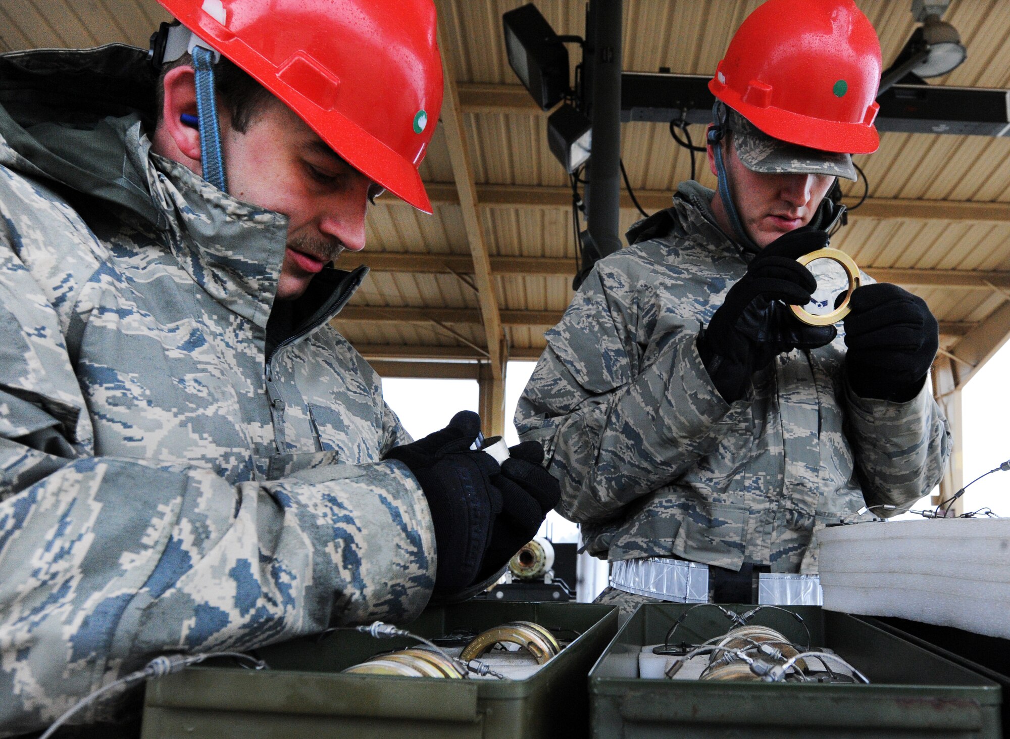 U.S. Air Force Tech. Sgt. David Coughtry, 20th Equipment Maintenance Squadron munitions flight conventional maintenance crew supervisor, and Senior Airman Nathanael Skidmore, 20th EMS munitions flight conventional maintenance crew, check over the fuse components to ensure they are usable at Shaw Air Force Base, S.C., Feb. 27, 2012. The 20th EMS munitions flight built inert guided bomb units to load on to Shaw?s F-16 Fighting Falcons to demonstrate warlike scenarios for an upcoming Operation Readiness Exercise. (U.S. Air Force photo by Senior Airman Tabatha McCarthy/Released)
