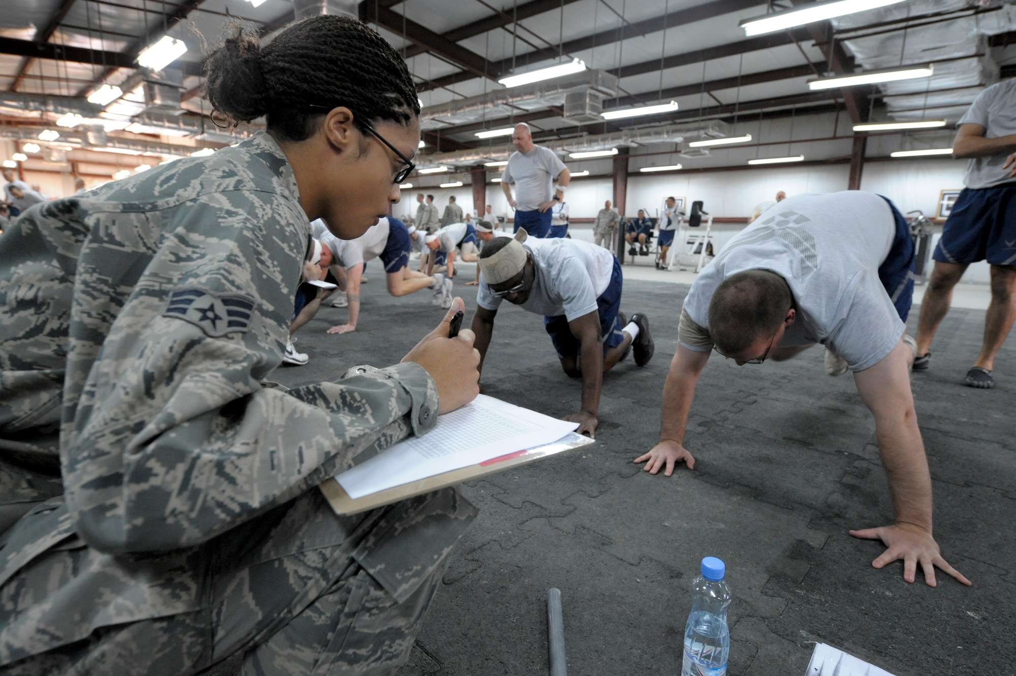 Senior Airman Mariah Rodriguez, 332nd Expeditionary Force Support Squadron member, counts mountain climbers repetitions performed during "Spanky's Challenge" at an undisclosed location in Southwest Asia, Feb. 27, 2012. Teams performed two sets of 332 mountain climbers.The number represented the 332nd Fighter Group, which Col. George "Spanky" Roberts commanded. Rodriguez is deployed from Grand Forks Air Force Base, N.D. (U.S. Air Force photo by Staff Sgt. Joshua J. Garcia/Released)