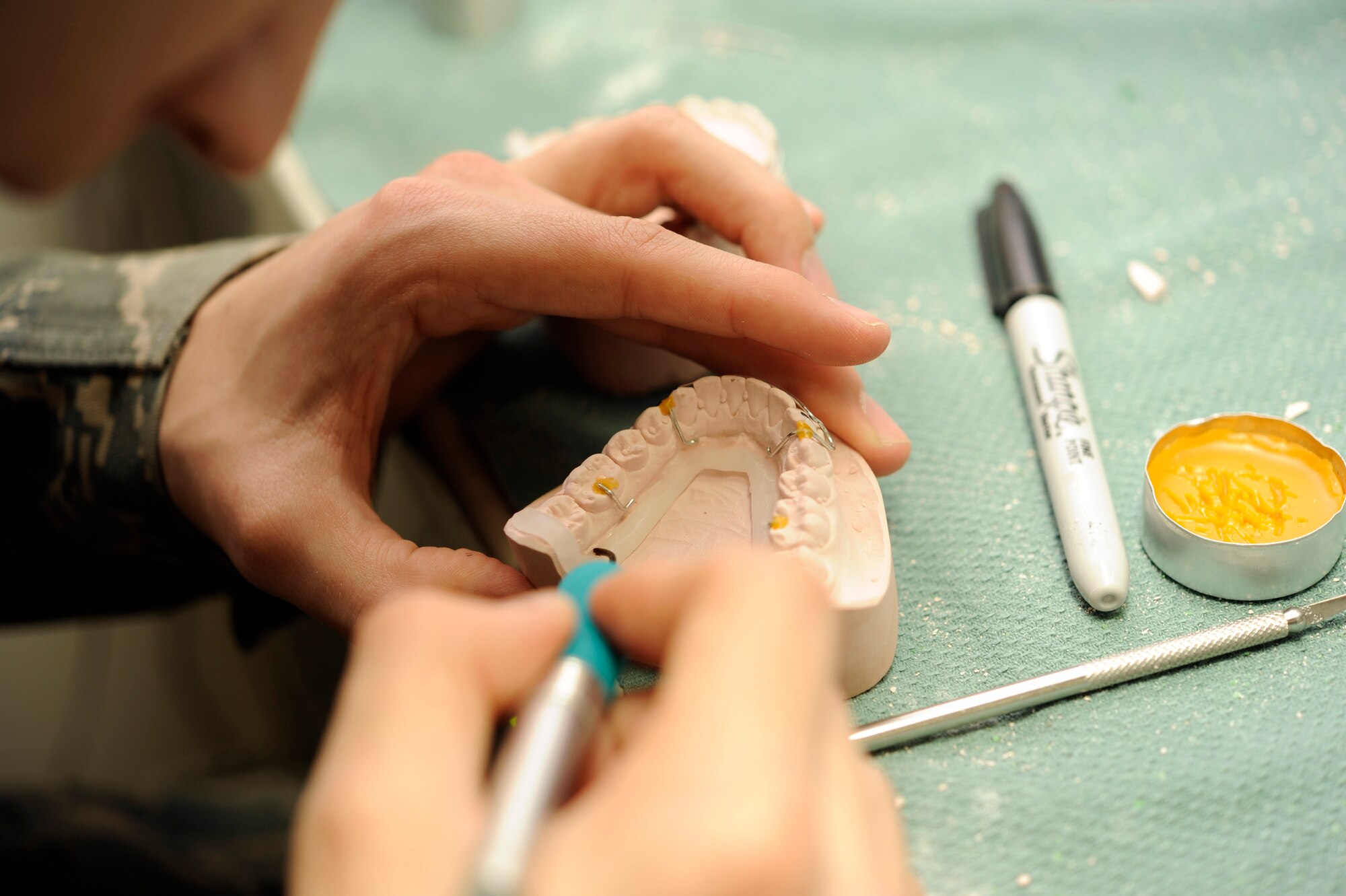 U.S. Air Force Staff Sgt. Dustin Nuss, 35th Dental Squadron dental lab technician, crafts a Hawley retainer at Misawa Air Base, Japan, Feb. 24, 2012. Dental lab technicians work on some dental aids that measure less than one millimeter in thickness. They must be precise in their work because the smallest mistake could cause a patient discomfort or pain. (U.S. Air Force photo by Airman 1st Class Kaleb Snay/Released)