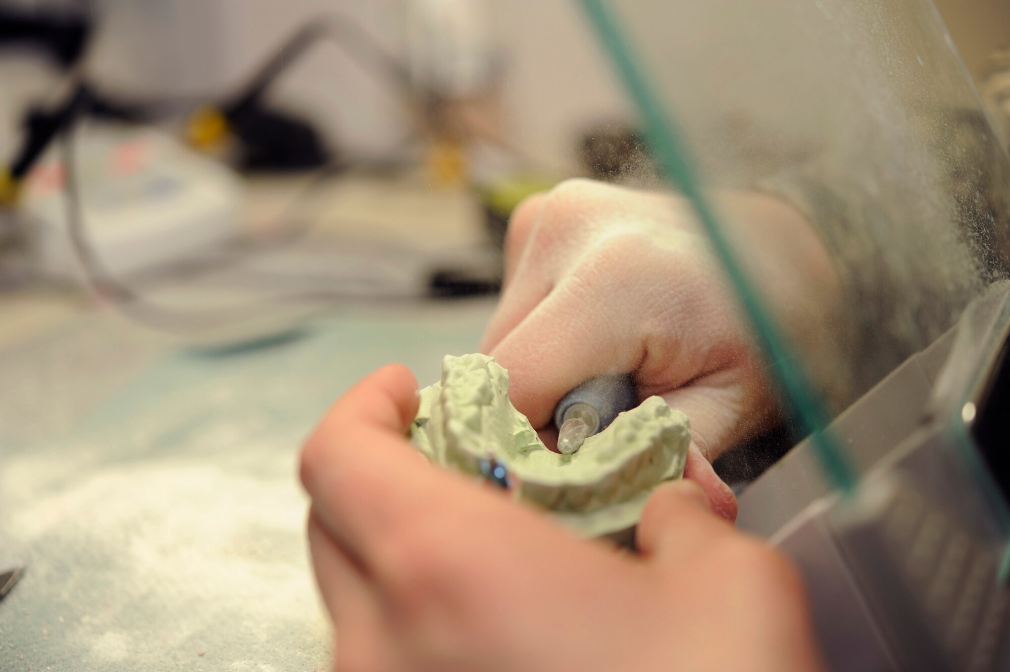 U.S. Air Force Staff Sgt. Cameron Dungey, 35th Dental Squadron dental lab technician, grinds a dental stone impression of a patient's teeth at Misawa Air Base, Japan, Feb. 24, 2012. The dental lab receives approximately 20 impressions from patients each day.  (U.S. Air Force photo by Airman 1st Class Kaleb Snay/Released)