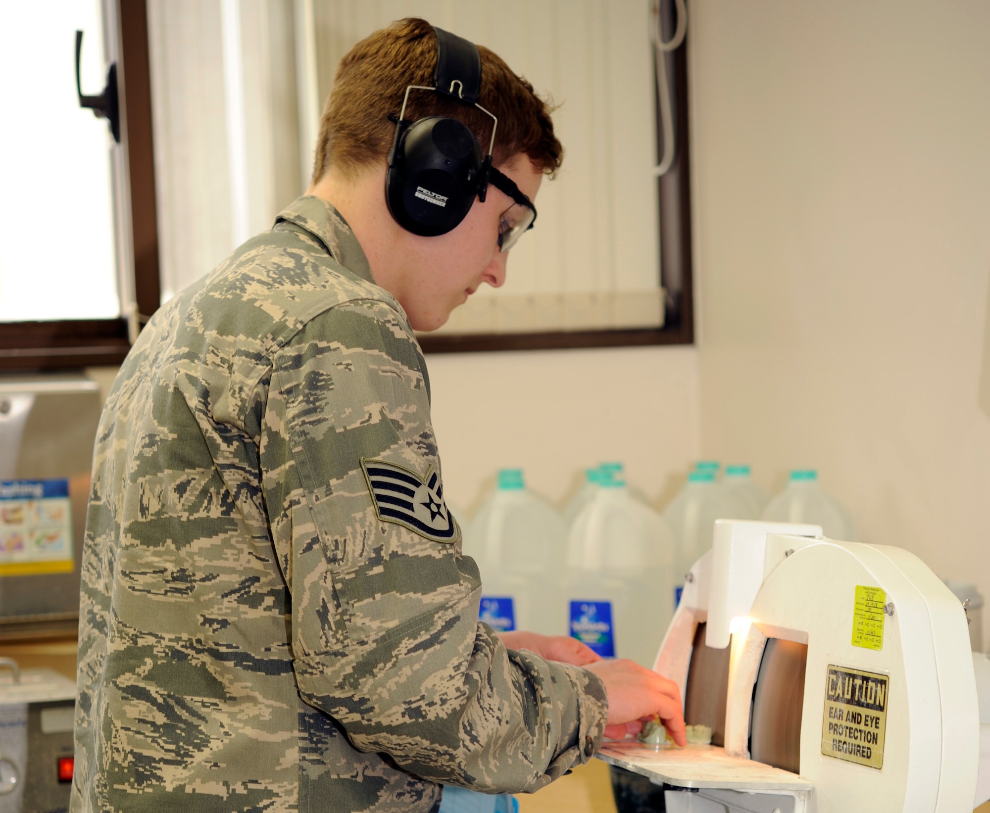 U.S. Air Force Staff Sgt. Cameron Dungey, 35th Dental Squadron dental lab technician, grinds the excess stone around a dental impression to smooth its edges at Misawa Air Base, Japan, Feb. 24, 2012. Dental impressions are used to create crowns, retainers or sports guards. The finished pieces are shown to the patient and fitted before being used. (U.S. Air Force photo by Airman 1st Class Kaleb Snay/Released)