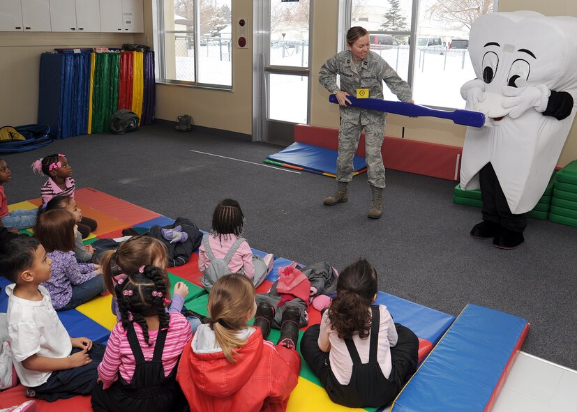 U.S. Air Force Capt. Meghan Vanderheiden, 35th Dental Squadron general dentist, demonstrates proper brushing techniques on "Tommy the Tooth" to children at the Yoiko Child Development Center at Misawa Air Base, Japan, Feb. 28, 2012. This visit wrapped up National Children's Dental Health Month, which allowed the 35 DS to educate children on the importance of brushing and flossing their teeth. (U.S. Air Force photo by Tech. Sgt. Marie Brown/Released)