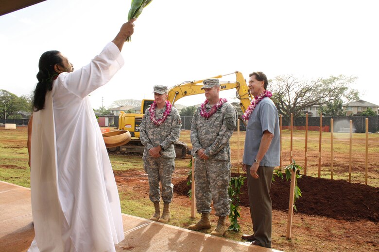 SCHOFIELD BARRACKS, HI - USAG-Hi Commander Col. Douglas Mulbury (second from left),  Lt. Col. Douglas Guttormsen, commander U.S. Army Corps of Engineers, Honolulu District, and Greg Helle, president, Absher Construction (contractor), listen as the Rev. Dr. Kaleo Patterson of the Pacific Justice and Reconciliation Center conducts the Hawaiian site blessing for the new 228 personnel UEPH on Montague Street. 