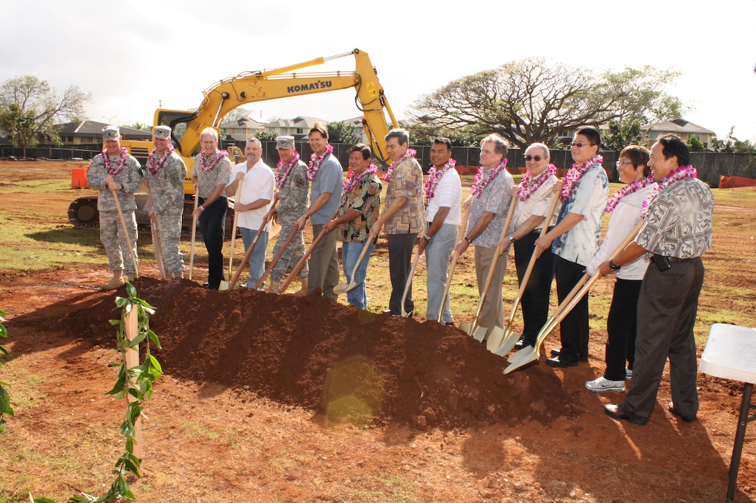 SCHOFIELD BARRACKS, HI - U.S. Army and Absher Construction officials man the Hawaiian o'o sticks and ceremonial gold shovels prior to the official ground breaking for the new 228 personnel UEPH on Montague Street.  Army personnel participating in the official groundbreaking were: Lt. Col. David Hurley, 25th ID Division Engineer (left), Lt. Col. Douglas Guttormsen, commander U.S. Army Corps of Engineers Honolulu District (second from left),  and Col. Douglas Mulbury, commander, USAG-HI (fifth from left). 