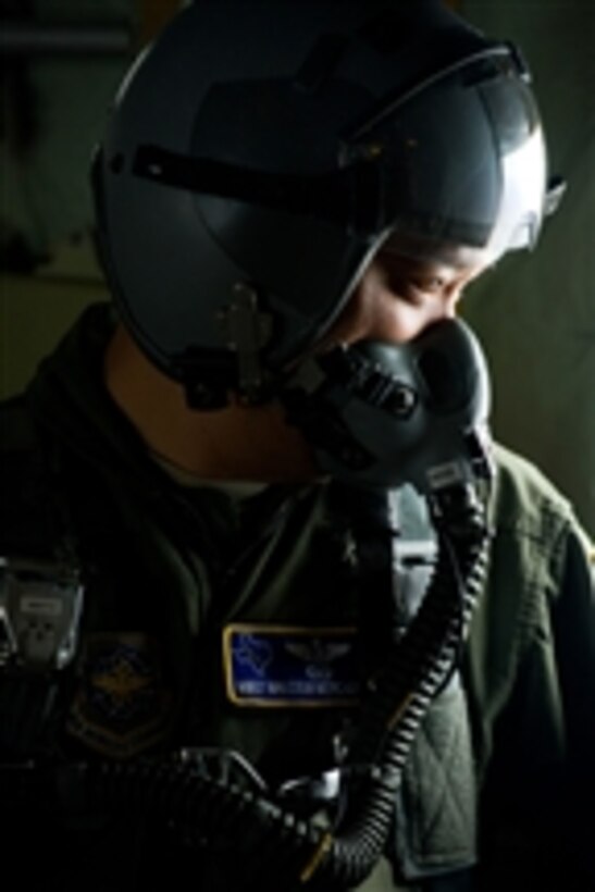 U.S. Air Force Master Sgt. Malcolm Mercado, a 40th Airlift Squadron loadmaster, is hooked up to the oxygen system prior to opening the ramp door on a C-130J Hercules aircraft flying at more than 10,000 feet during a training mission over Dyess Air Force Base, Texas, on Feb. 23, 2012.  