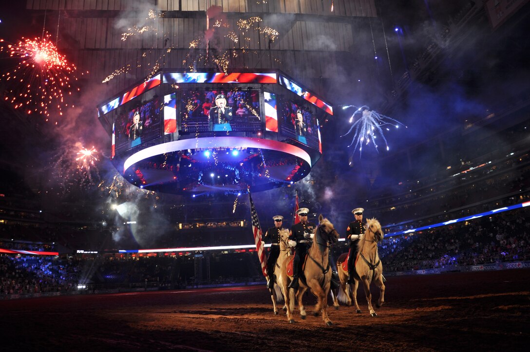 The Marine Corps Mounted Color Guard marches under a fireworks presentation during a rodeo event in Houston. Gunnery Sgt. Mike Bate (left rear), had led the Marines of the MCG in dozens of parades, rodeos and events.