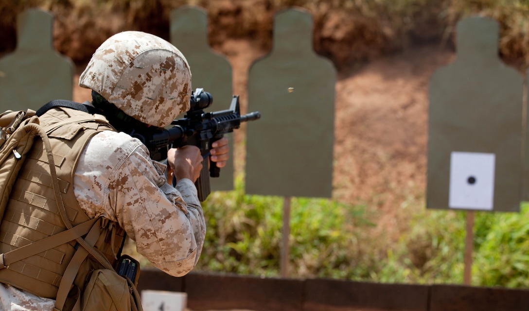 PUULOA RIFLE RANGE, Hawaii -Capt. Marcos Azua, comptroller for Headquarters and Service Battalion, U. S. Marine Corps Forces, Pacific, fires from the five-yard line during Table 3 Intermediate Combat Rifle Marksmanship Training with the M4 Carbine assault rifle May 5 here. MarForPac Marines began Table 3 qualifications in January as part of a Corps-wide effort to provide Marines additional weapons training. The majority of Marines qualify annually on the Table 1, known distance, and Table 2, field fire, courses of fire.