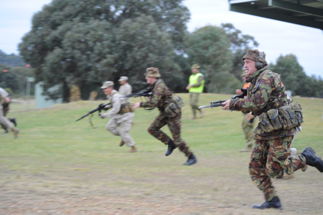 PUCKAPUNYAL RANGE, Victoria, Australia-Lance Cpl. Pete Breidahl, a native of Wanganvi, New Zealand, charges towards a bayonet target along with fellow Kiwi soldiers and U.S. Marines May 15, during the 2011 Australian Army Skill at Arms Meeting (AASAM). The week-long meeting pit military representatives from partner nations in competition in a series of grueling combat marksmanship events. Represented nations include Canada, France (French Forces New Caledonia), Indonesia, Timor Leste, Brunei, Netherlands, U.S., Papua New Guinea, New Zealand, Singapore, Malaysia, Thailand as well as a contingent of Japanese observers. (U.S. Air Force Photo by Master Sgt. Cohen A. Young/Released)