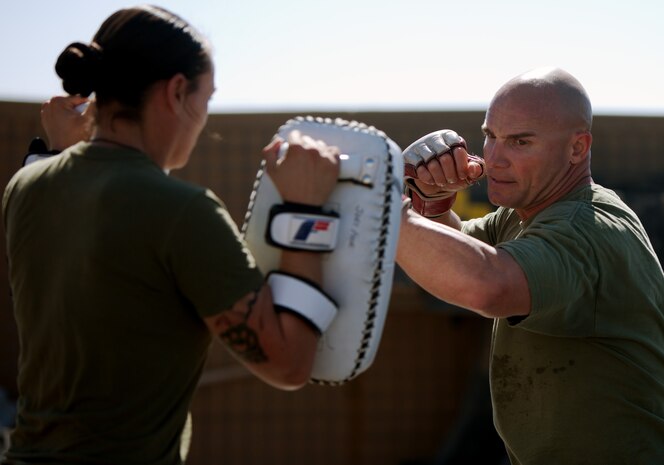 U.S. Marine Gunnery Sgt. Jason Rossman, the company gunnery sergeant of Charlie Company, 3rd Assault Amphibious Battalion, currently attached to Combat Logistics Battalion 1, and 37-year-old native of Grand Junction, Colo., strikes training pads during a Marine Corps Martial Arts class here, Feb. 29. Rossman is a 4th degree black belt MCMAP instructor, and has been teaching Marines martial arts since 2001. Rossman recently graduated 20 Marines as MCMAP instructors. In between his duties as the company gunny, Rossman teaches various levels of MCMAP and other martial arts to Marines serving aboard Camp Dwyer.