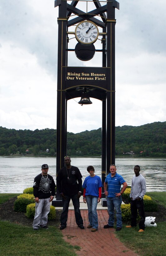 Five Marines with Combat Logistics Regiment 2, pose for a photo in front of a memorial for fallen service members during a memorial motorcycle ride in honor of Cpl. John C. Bishop, September 10, 2011. Bishop was serving as an infantryman with 2nd Battalion, 9th Regiment, 2nd Marine Division, at the time of his death.  (U.S. Marine Corps photo by Pfc. Franklin E. Mercado)