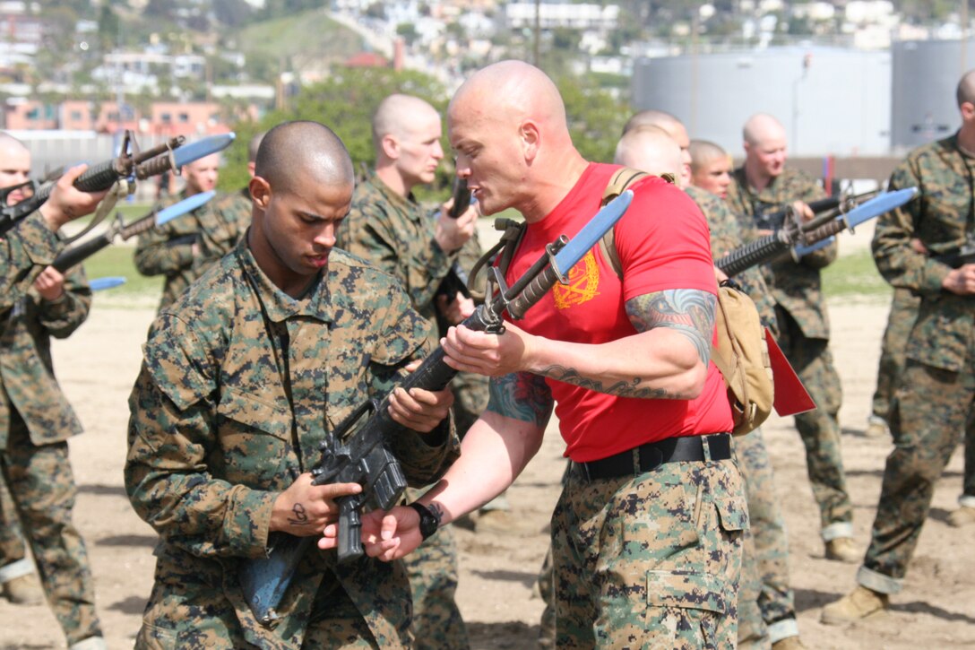 Drill Instructors help recruits from Company B., 1st Recruit Training Battalion with bayonet techniques as part of the Marine Corps Martial Arts program Feb. 29 aboard Marine Corps Recruit Depot San Diego. Recruits of Co. B. are in week two of Recruit Training.