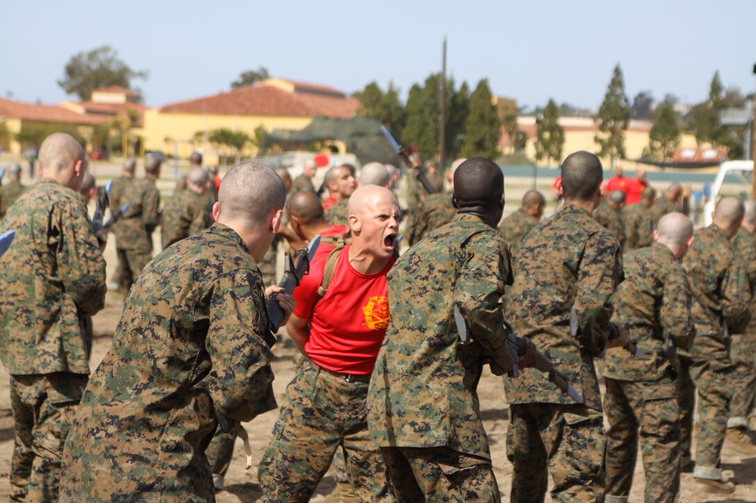 Sgt. William A. Getts, chief drill instructor, Company B, 1st Recruit Training Battalion, assists recruits by correcting them while they execute bayonet assault techniques as part of the Marine Corps Martial Arts Program training Feb. 29 aboard Marine Corps Recruit Depot San Diego. The recruits are taught mental and physical discipline to prepare them for a combat situation.