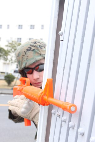 Cpl. Jose J. Briones, Marine Wing Support Squadron 171 combat engineer, peeks around a corner to check for enemy::r::::n::threats during a patrolling exercise here Feb. 18. MWSS-171 Marines and sailors practice patrolling exercises in order::r::::n::to ensure mission effectiveness in a combat environment.