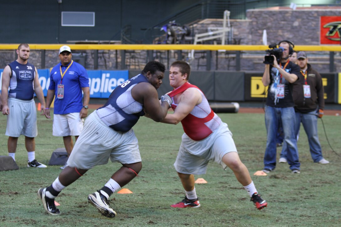 Two student-athletes face off during the USMC Proving Ground Combine at Chase Field, Jan. 2, 2012. The Proving Ground Combine gave high school juniors the opportunity to showcase their skills and compete for a chance to play in next year's Semper Fidelis All-American Bowl.