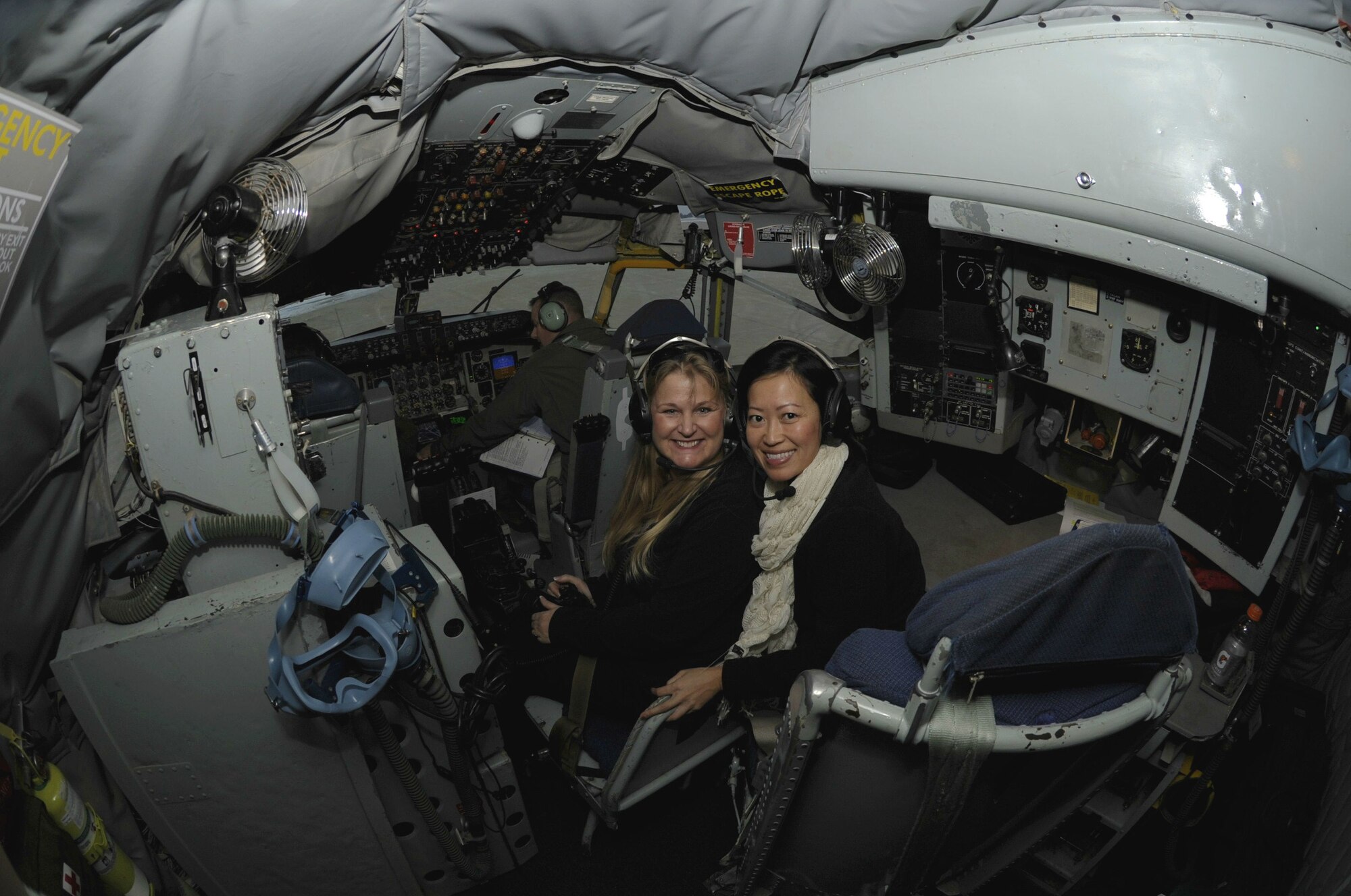 Lorelei Hinsvark, wife of Lt. Col. Brian Hinsvark, 8th Mission Support Group deputy commander, and See Vang Lopez, wife of Maj. Andres Lopez, 8th Security Forces Squadron deputy commander, wait for takeoff as pilots of the 909th Air Refueling Squadron from Kadena Air Base, Japan, perform final checks Dec. 28, 2011 at Kunsan Air Base, Republic of Korea. As part of a joint effort between the 80th Fighter Squadron and the 909th ARS, military spouses visiting the area were given the opportunity to fly on the air refueling. (U.S. Air Force photo by Senior Airman Jessica Hines/Released)