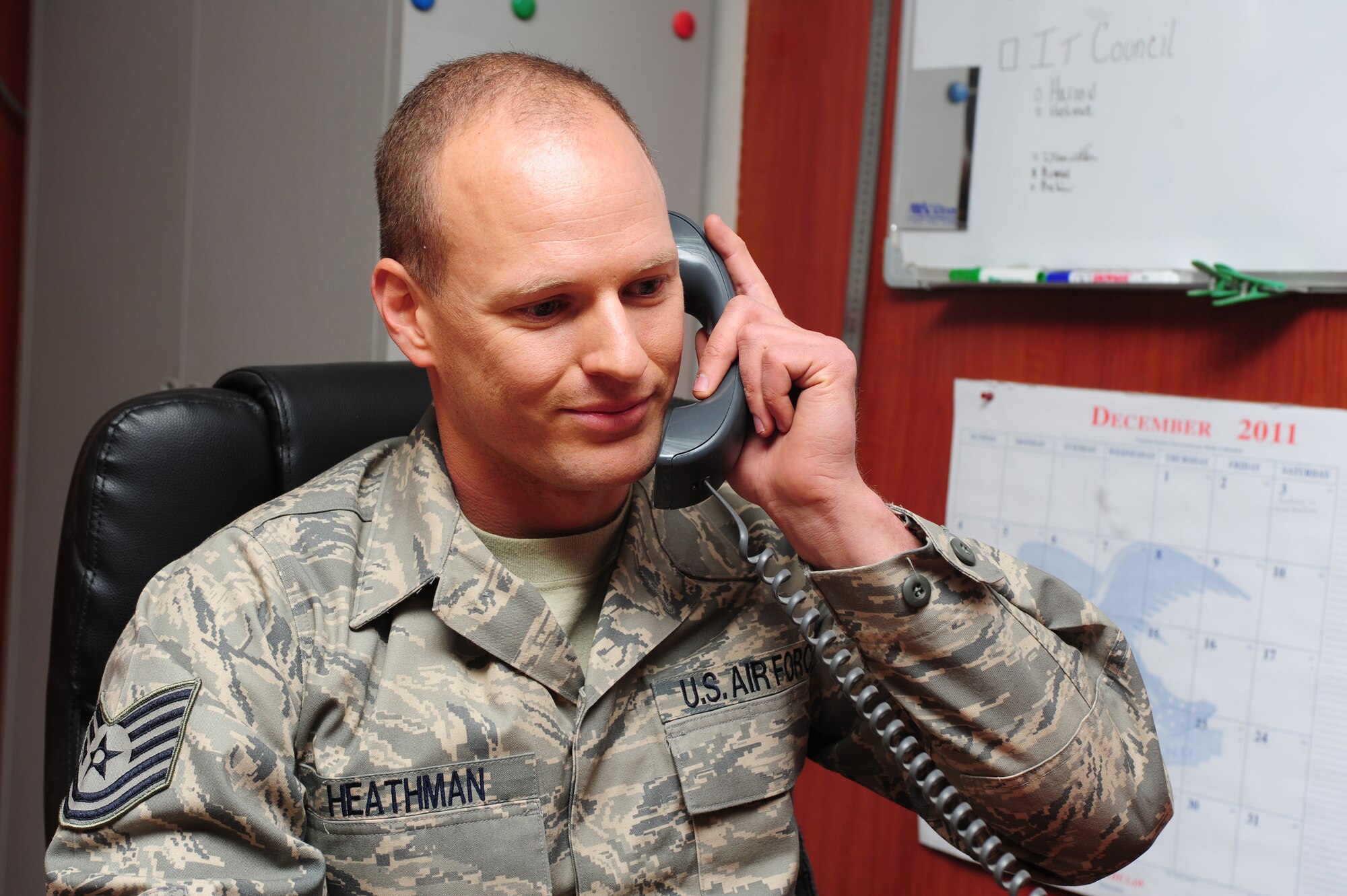 Tech. Sgt. Charles Heathman, an adviser with the 438th Air Expeditionary Wing , speaks to Secretary of Defense Leon Panetta on the telephone New Year's Day, Jan. 1, 2012, at Kabul International Airport. Heathman was hand-picked as the Air Force representative to receive a call from Panetta. (U.S. Air Force photo by Staff Sgt. Nadine Y. Barclay)