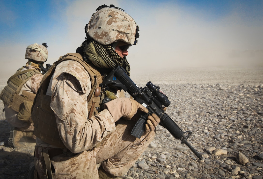 Two Marines from 2nd Platoon, Alpha Company, 9th Engineer Support Battalion, 2nd Marine Logistics Group (Forward), use a metal detector to sweep a culvert during a route reconnaissance mission of Route Red, which extends from Highway 1 to Shir Ghazay, Jan. 3.  The purpose of the mission was to document inclines and declines in the route, sharpness of curves, the shortest width during the route, and where culverts were located or needed to be placed on the route to prevent wash out. (U.S. Marine Corps photo by Cpl. Meredith Brown)