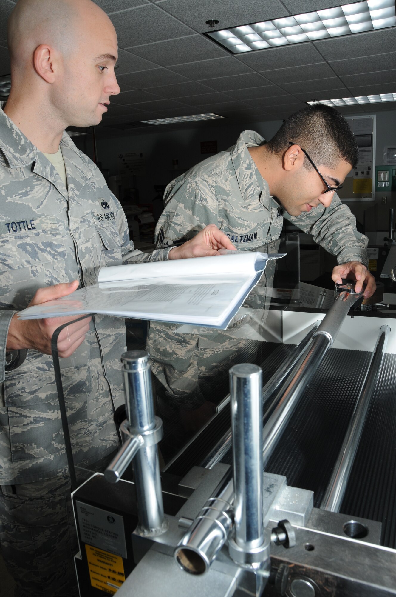 Tech. Sgt. Kenneth Tottle, 335th Training Squadron instructor, and Airman 1st Class Kevin Saltzman, one of his students, review the calibration of a torque wrench using a torque calibrator during the precision measurement equipment laboratory course in Wolfe Hall at Keesler Air Force Base, Miss., Jan. 3, 2012.  PMEL is one of the courses at Keesler expecting an influx of Saudi Arabian students as part of an agreement with the Saudi government to purchase 85 F-15A fighter jets and upgrade its current fleet of 70 F-15s at an estimated cost of $29.4 billion.  The program is the largest foreign military sales contracts in U.S. history.  (U.S. Air Force photo by Kemberly Groue)