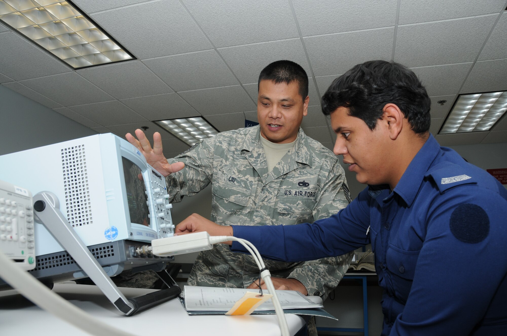 Tech. Sgt. Wai Chung Liu, 335th Training Squadron instructor, and Airman Basic Mohammed Almutairi, a student from Saudi Arabia, reviews the use of a digital oscilloscope during the precision measurement equipment laboratory course in Wolfe Hall at Keesler Air Force Base, Miss., Jan. 3, 2012.  PMEL is one of the courses at Keesler expecting an influx of Saudi Arabian students as part of an agreement with the Saudi government to purchase 85 F-15A fighter jets and upgrade its current fleet of 70 F-15 at an estimated cost of $29.4 billion.  The program is the largest foreign military sales contracts in U.S. history.  (U.S. Air Force photo by Kemberly Groue)