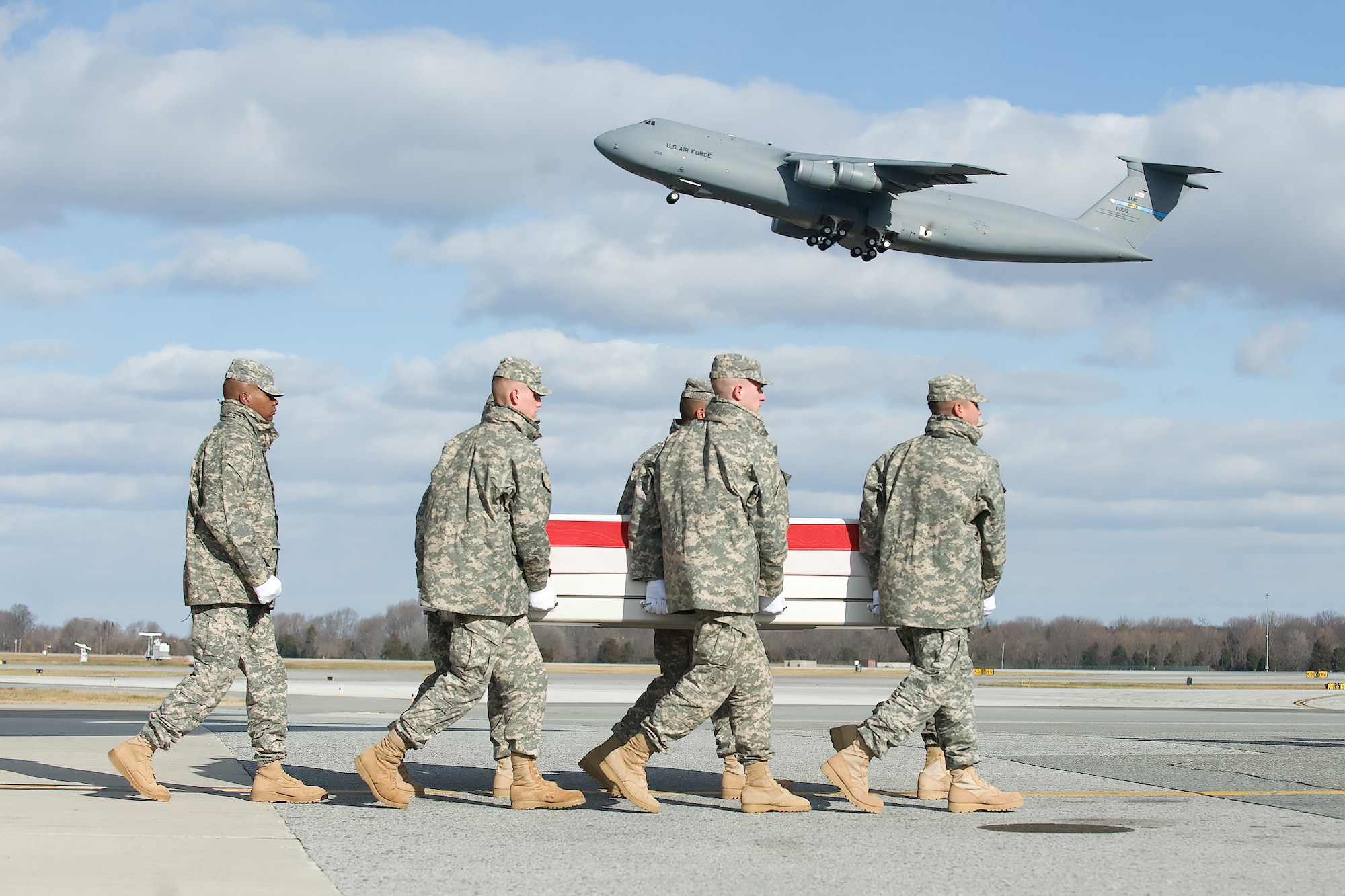A U.S. Army carry team transfers the remains of Army Spc. Pernell J. Herrera of Espanola, N.M., at Dover Air Force Base, Del., Jan. 3, 2012. Herrera was assigned to the 1st Battalion, 171st Aviation Regiment, Santa Fe, N.M. (U.S. Air Force photo/Adrian R. Rowan)
