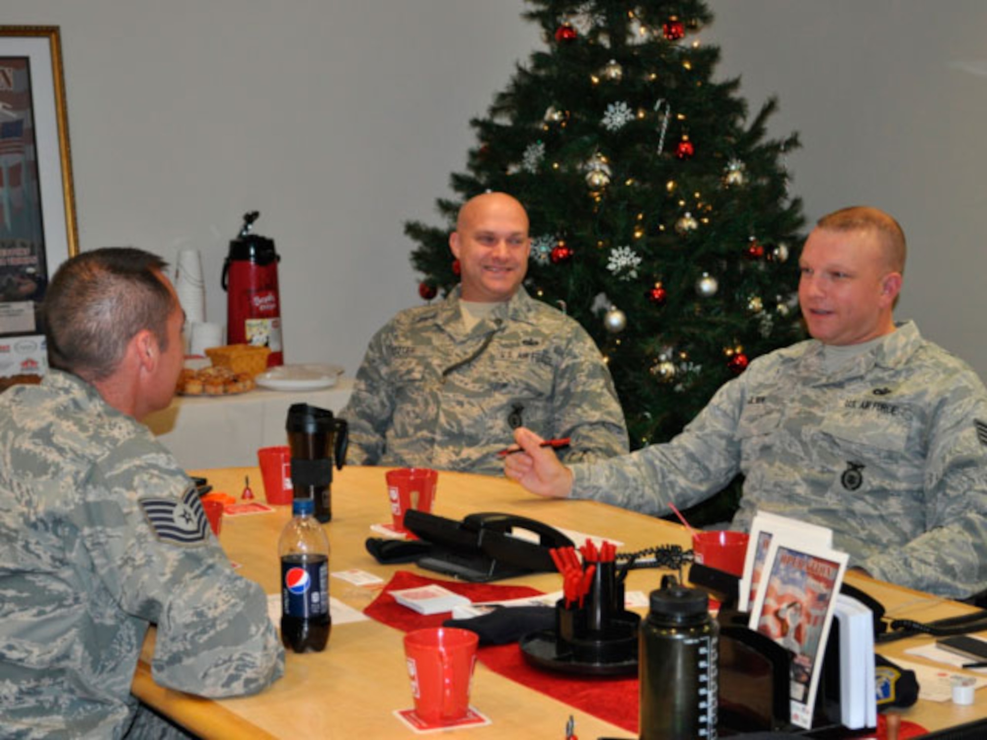 TSgt Jason Schroeder, TSgt Shawn Potter, SSgt Kylan Olsen , 142 Security Forces Squadron taking a moment to enjoy coffee prior to the phone lines opening up. (photo provided by 142 Security Forces Squadron)