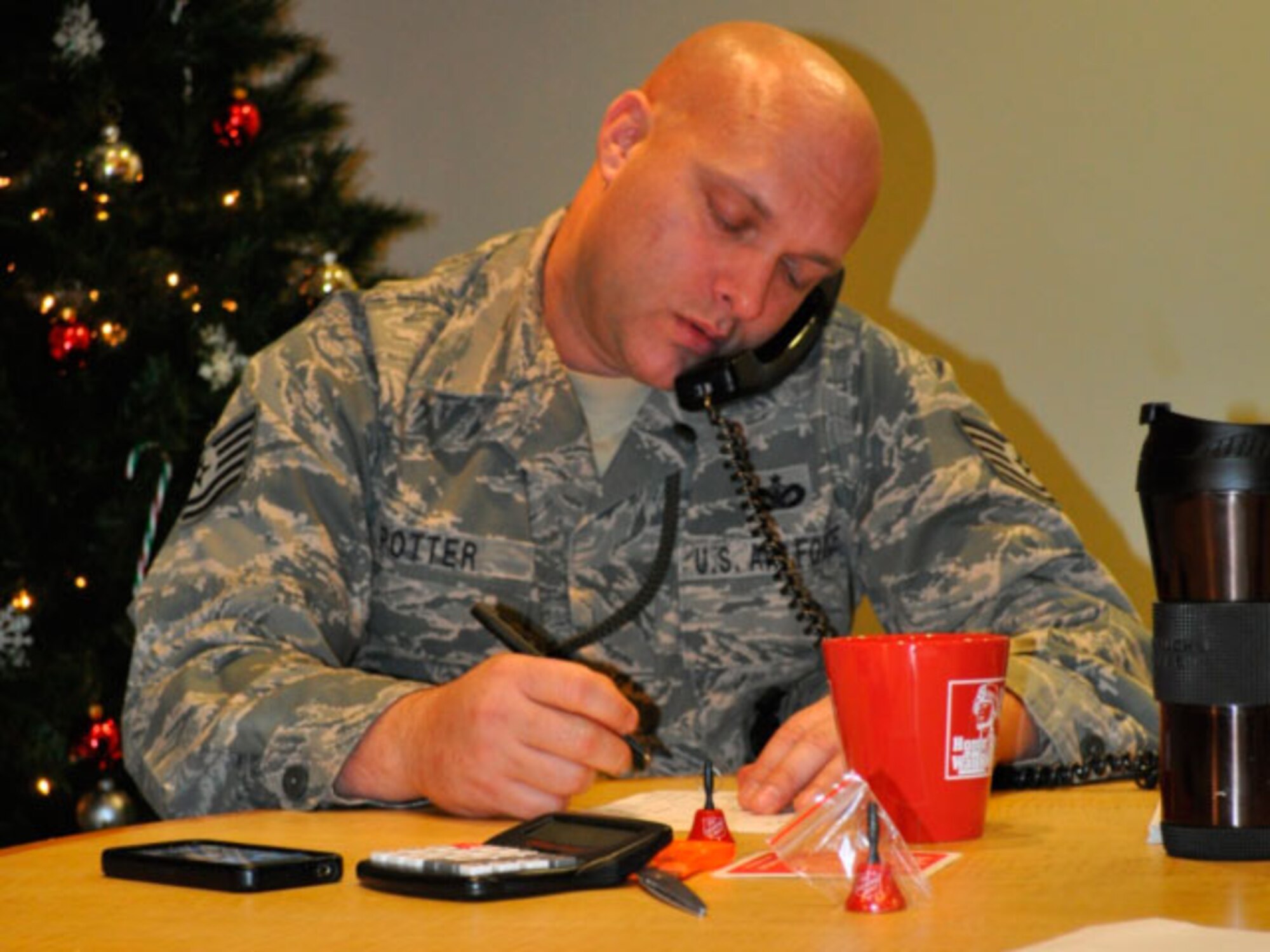 Technical Sergeant Shawn Potter, 142 Security Forces Squadron taking a donation from a generous caller. (photo provided by 142 Security Forces Squadron)