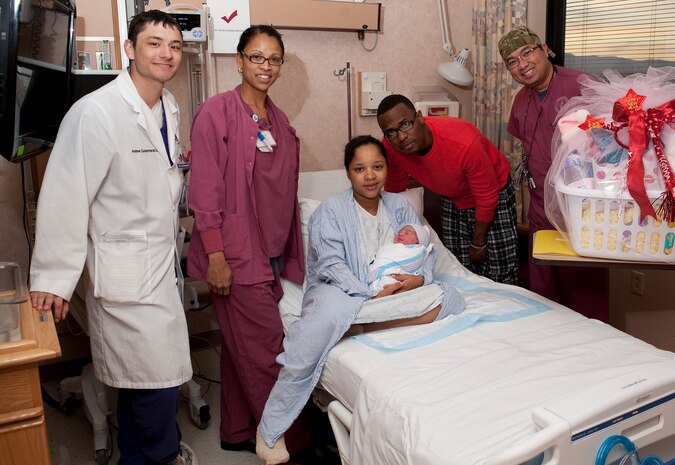 U.S. Air Force Staff Sgt. Randy Williams and his wife, Cynthia Williams, pose with hospital staff and their newborn daughter, Randi, at the Mike O'Callaghan Federal Hospital Jan. 2, 2012, at Nellis Air Force Base, Nev. Born Jan. 2 at 1:41 p.m., Randi was the first child born at Nellis in 2012. (U.S. Air Force photo by Staff Sgt. Christopher Hubenthal/Released)