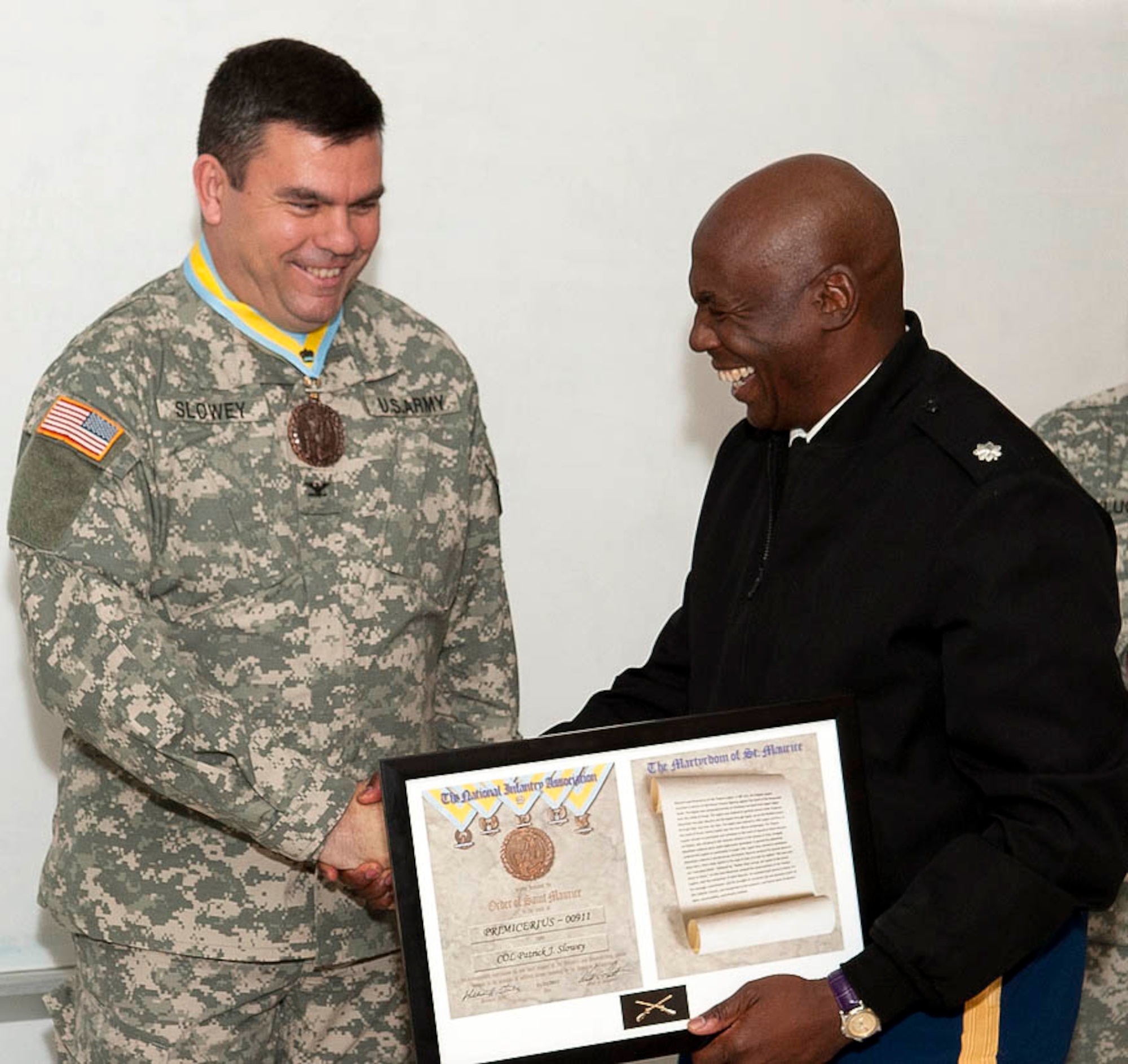 Col. Patrick J. Slowey, Army Support Activity-Dix commander, is presented The Order of Saint Maurice Medallion and inducted into the Honorable ORDER OF SAINT MAURICE- Primicerius Level by Lt. Col. Hugh Elmore, 1-307 Infantry Battalion, commander and National Infantry Association North East Patriot Chapter President. Col. Slowey was caught off guard when the award was presented because he thought that he was there just to give a holiday safety brief. (U.S. Air Force photo by Wayne Russell/Released)	