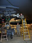 MINOT AIR FORCE BASE, N.D. – Weapons standardization evaluators from the 5th Maintenance Group, attach a GBU-38 GPS guided bomb to the heavy stores adapter beam of a B-52H Stratofortress, here Dec. 29. The weapons standardization section trains, evaluates and certifies personnel on munitions removal and installation on B-52s. (U.S. Air Force photo/Senior Airman Desiree Esposito)