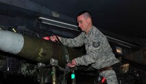 MINOT AIR FORCE BASE, N.D. – Tech. Sgt. Jamie Mikus, 5th Maintenance Group weapons standardization evaluator, attaches a GBU-38 GPS guided bomb to the heavy stores adapter beam of a B-52H Stratofortress, here Dec. 29. The weapons standardization section trains, evaluates and certifies personnel on munitions removal and installation on B-52s. (U.S. Air Force Photo/Senior Airman Desiree Esposito)