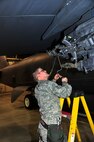 MINOT AIR FORCE BASE, N.D. – Staff Sgt. Jordan Ellis, 5th Maintenance Group weapons standardization evaluator, attaches a 1760 cable to the heavy stores adapter beam of a B-52H Stratofortress in preparation for a GBU-38 GPS guided bomb loading, here Dec. 29. The weapons standardization section trains, evaluates and certifies personnel on munitions removal and installation on B-52s. (U.S. Air Force Photo/Senior Airman Desiree Esposito)