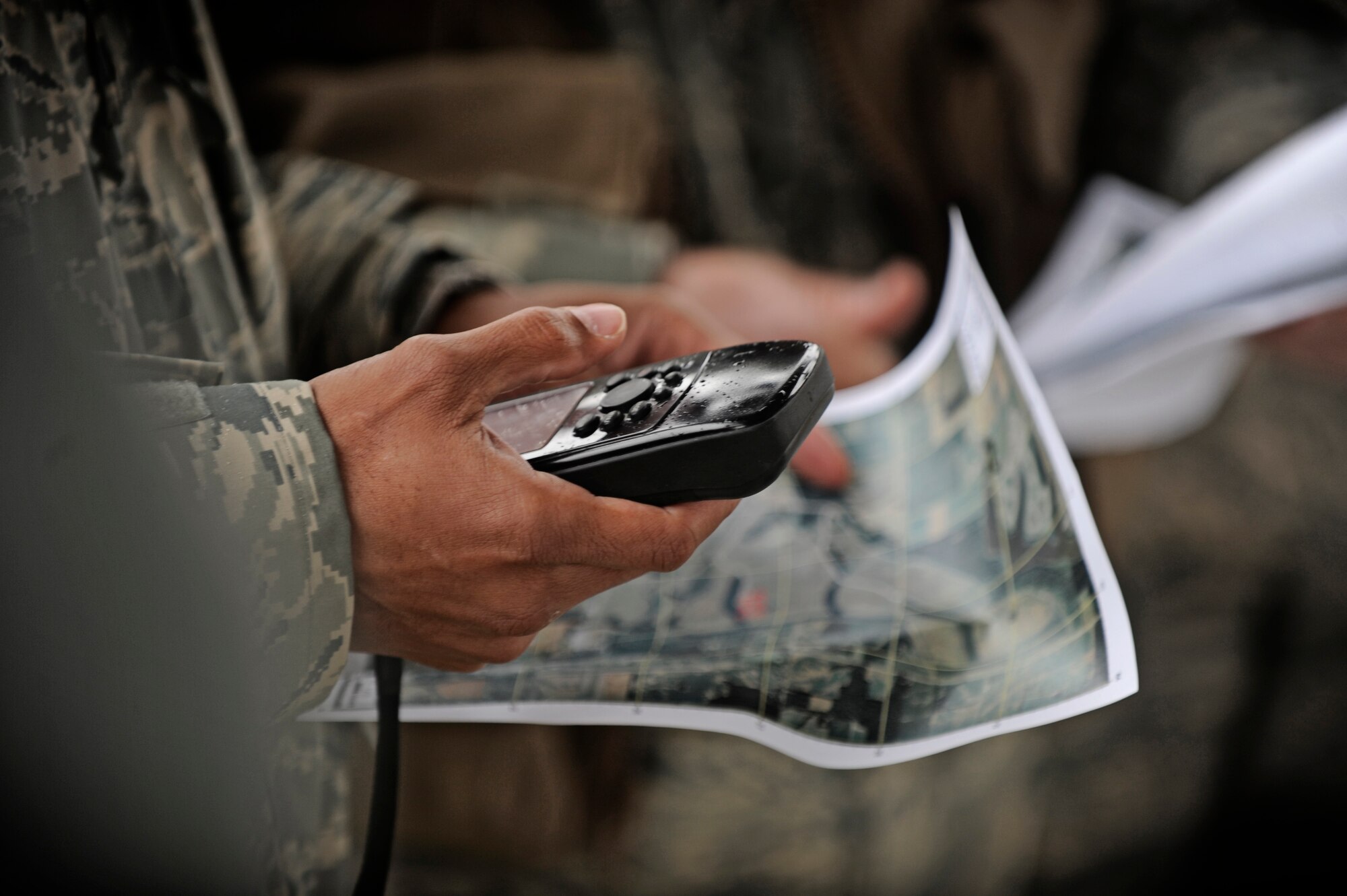 Trainees study their maps and GPS devices during the land navigation portion of their survival, evasion, resistance, escape (SERE) training Dec. 13 at Scott Air Force Base, Ill. Aircrew members, and persons who have been deemed at risk of isolation are required to attend refresher SERE training every three years to make sure they are proficient with the techniques and skills that will keep them alive. (U.S. Air Force photo/ Staff Sgt. Ryan Crane)