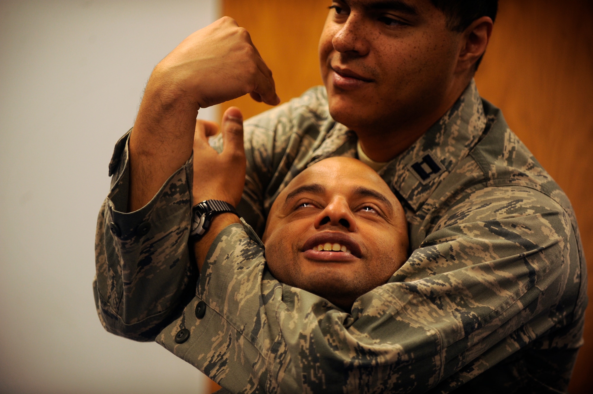 Capt. Luis Garces, 458th Airlift Squadron, practices a blood choke on Senior Master Sgt. Rodney Lindsey, 375th Air Evacuation Squadron, during the combative portion of their survival, evasion, resistance, escape (SERE) training Dec. 13 at Scott Air Force Base, Ill. Aircrew members, and persons who have been deemed at risk of isolation are required to attend refresher SERE training every three years to make sure they are proficient with the techniques and skills that will keep them alive. (U.S. Air Force photo/ Staff Sgt. Ryan Crane)