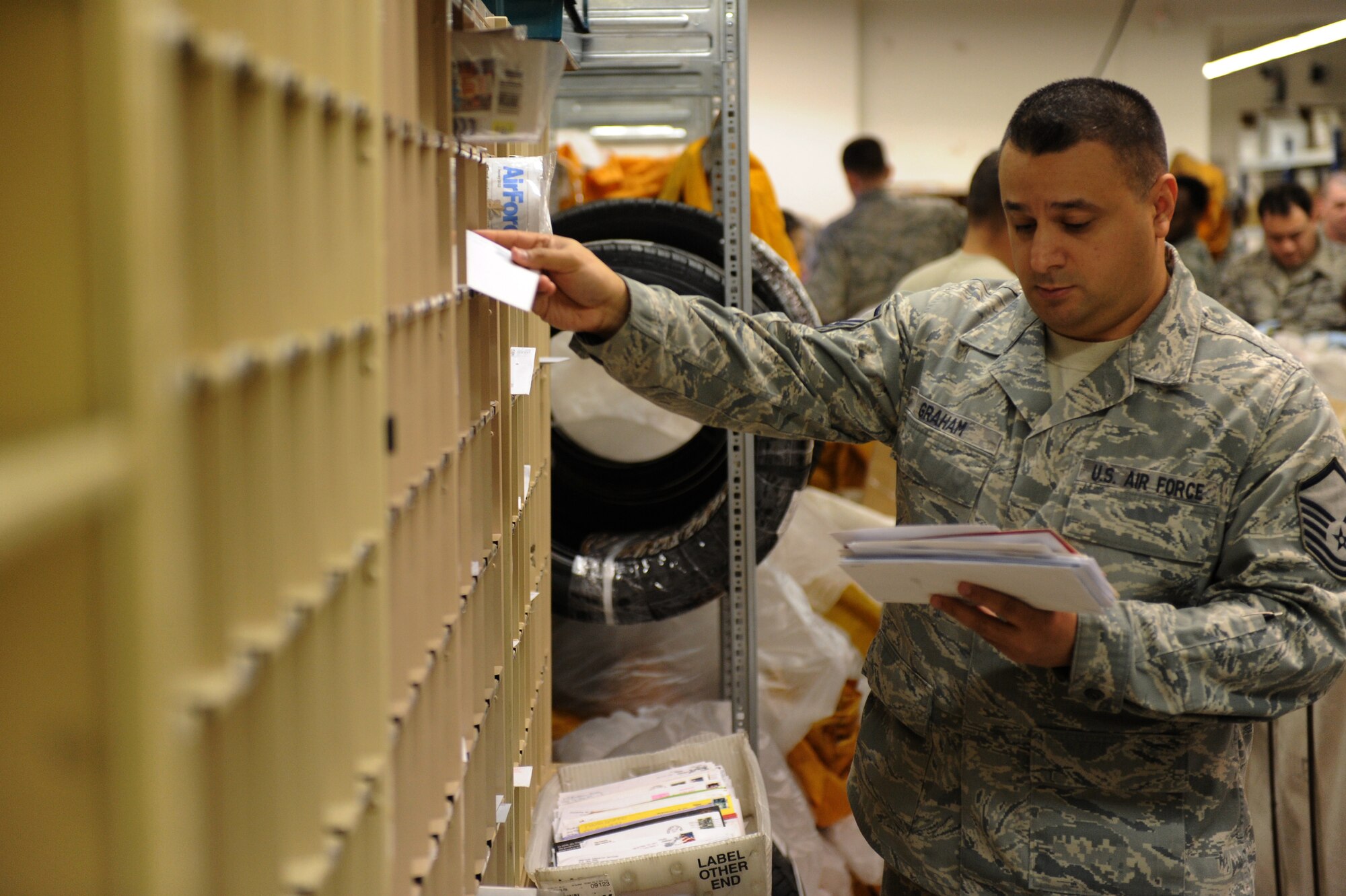 SPANGDAHLEM AIR BASE, Germany – Master Sgt. Melvin Graham, 52nd Communication Squadron post master, sorts mail to be picked up at the Spangdahlem Post Office here Jan. 2. The post office processed 423,000 pounds of inbound mail from Nov. 1 to Dec. 31 to ensure Saber Airmen and their families received their packages for the holiday season. (U.S. Air Force photo/Airman 1st Class Matthew B. Fredericks)
