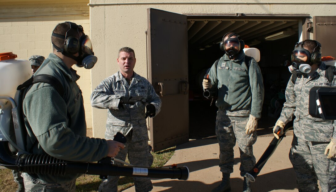 Airmen demonstrate proper person protective equipment wear techniques during field training at the 366th Training Squadron's Pest Management Apprentice Course Dec 16, 2011 at Sheppard Air Force Base, Texas.  Students learn pest management missions for both home station and the contingency environment during the 33 academic days and six major blocks of instruction. (U.S. Air Force photo/Dan Hawkins)