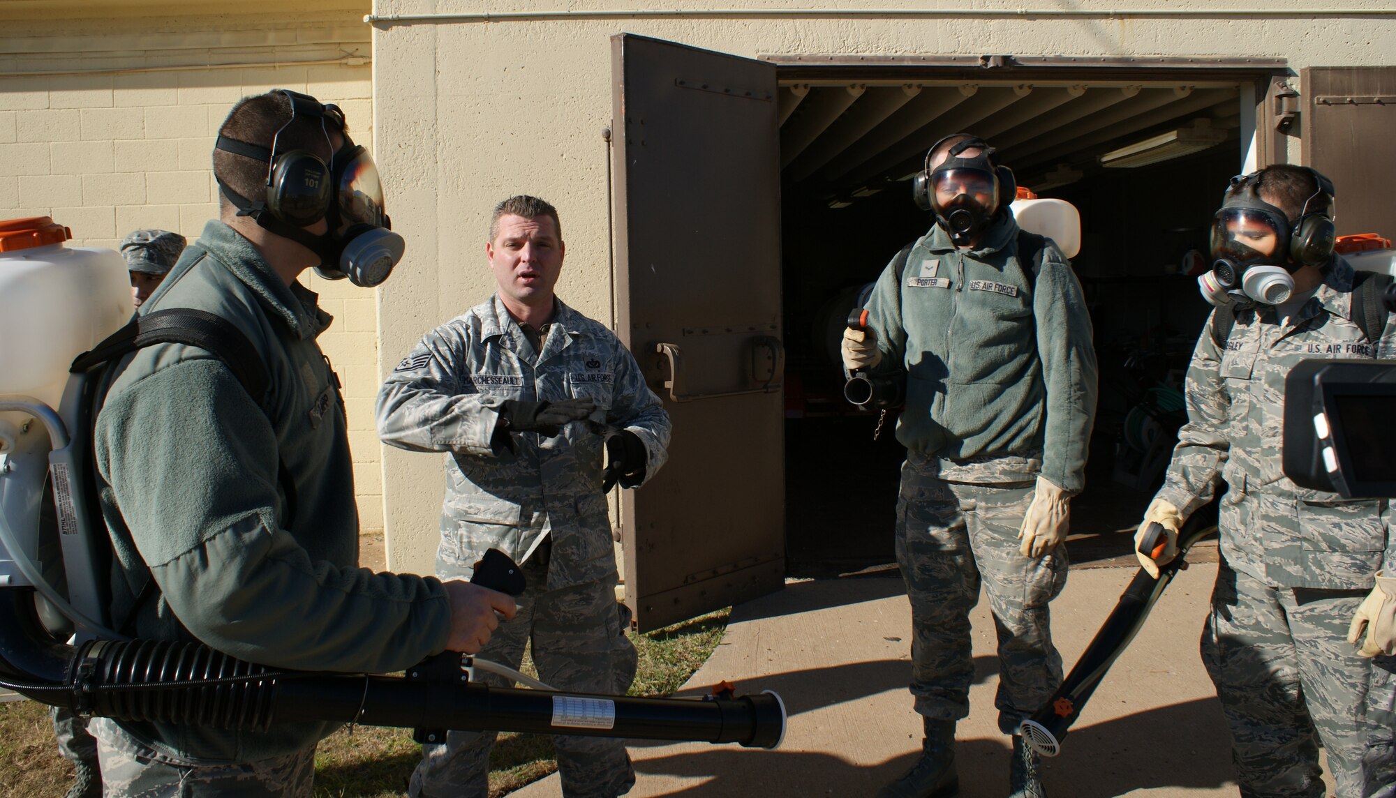 Airmen demonstrate proper person protective equipment wear techniques during field training at the 366th Training Squadron's Pest Management Apprentice Course Dec 16, 2011 at Sheppard Air Force Base, Texas.  Students learn pest management missions for both home station and the contingency environment during the 33 academic days and six major blocks of instruction. (U.S. Air Force photo/Dan Hawkins)