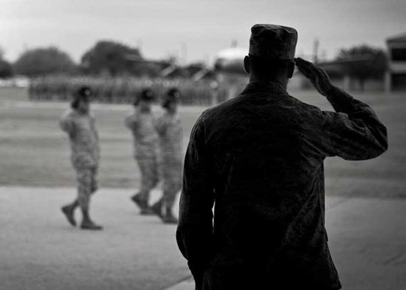 Col. Sal Nodjomian, the 96th Air Base Wing commander, salutes the new Airmen at the basic military training graduation parade at Lackland Air Force Base, Texas.  (Courtesy photo)
