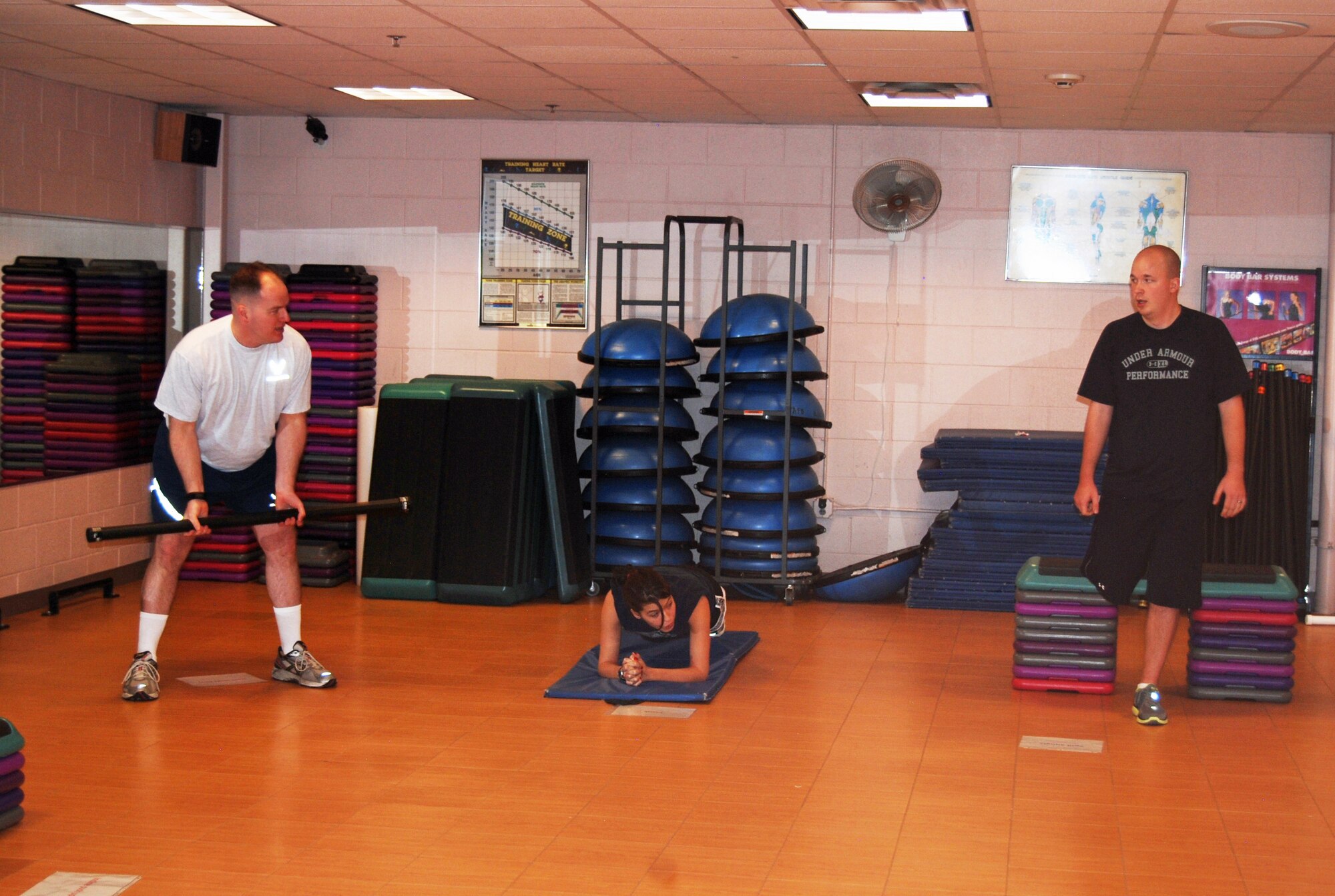 Participants in the Domination Boot Camp class do three of 15 different exercises in a circuit workout. The class is offered Monday through Friday at 7:30 a.m. and 3:30 p.m. and is currently open to all ID cardholders. The class is set up to promote a life-long fitness program. (U.S. Air Force photo/Lea Johnson)